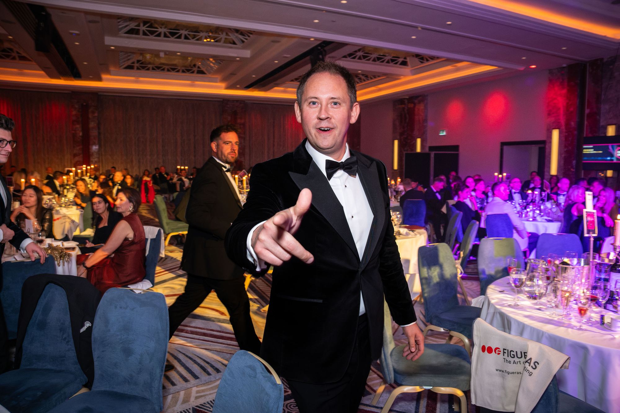 Jonathan Garforth pointing to the camera in the ballroom at the awards